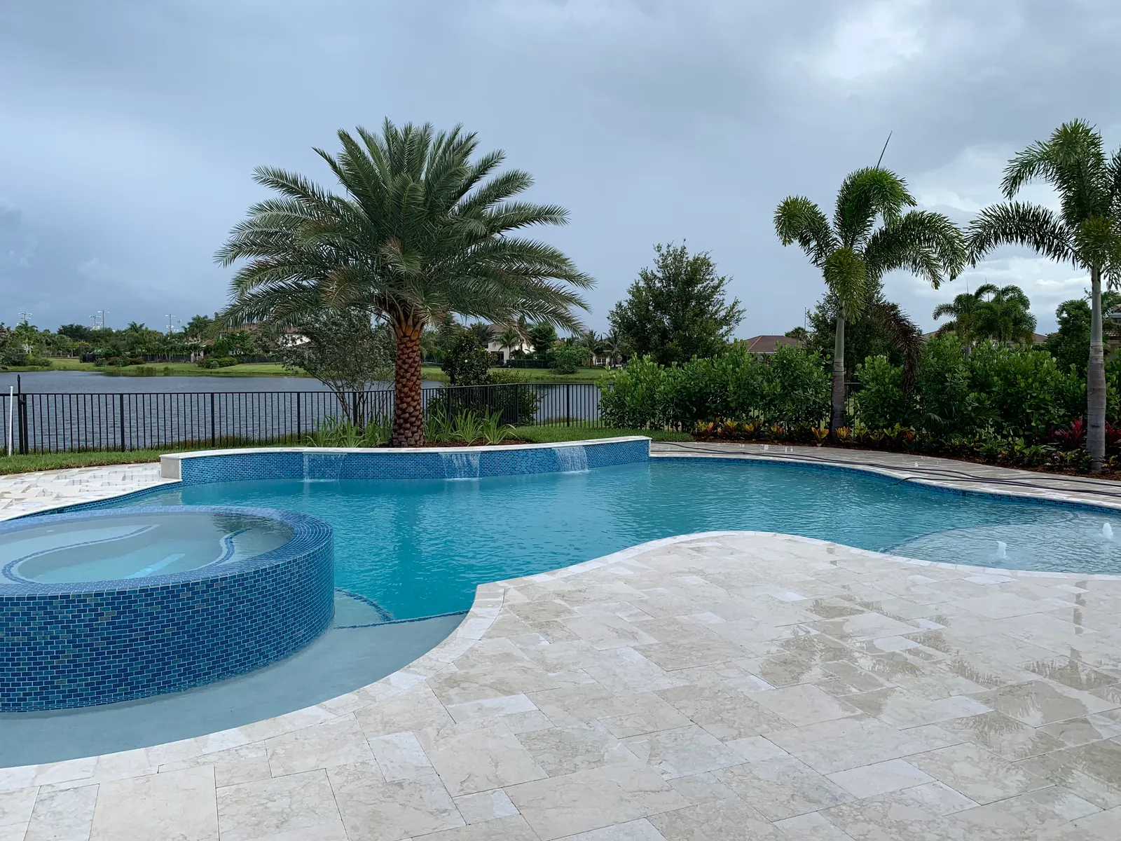 Jupiter pool deck travertine surface treatment, water-reflective finish